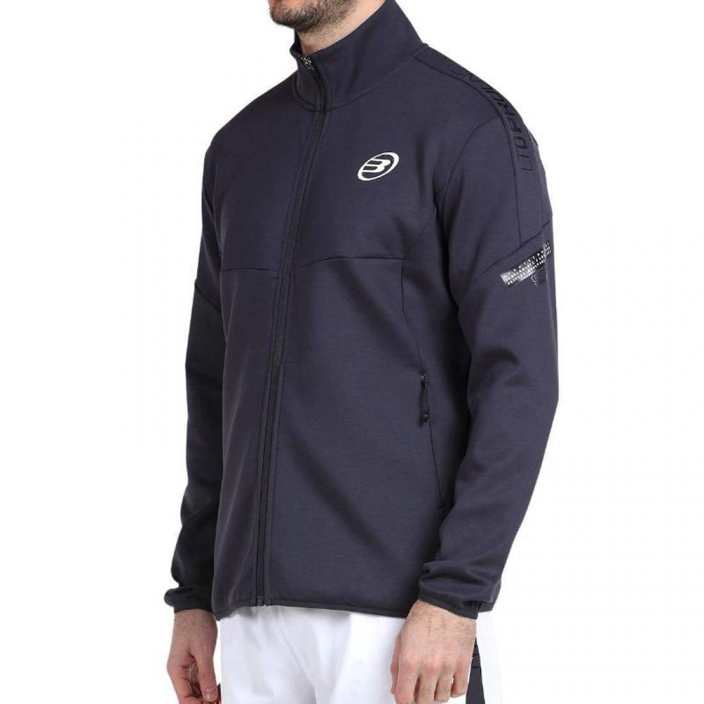 chaqueta-bullpadel-noble-azul-sombra-1-es-2-1100x1100.webp